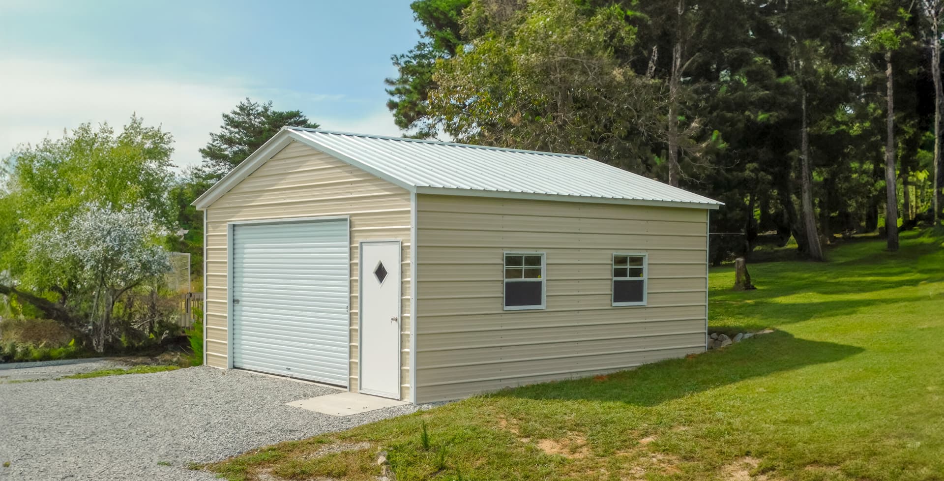 Metal residential garage building with roll-up doors and concrete driveway